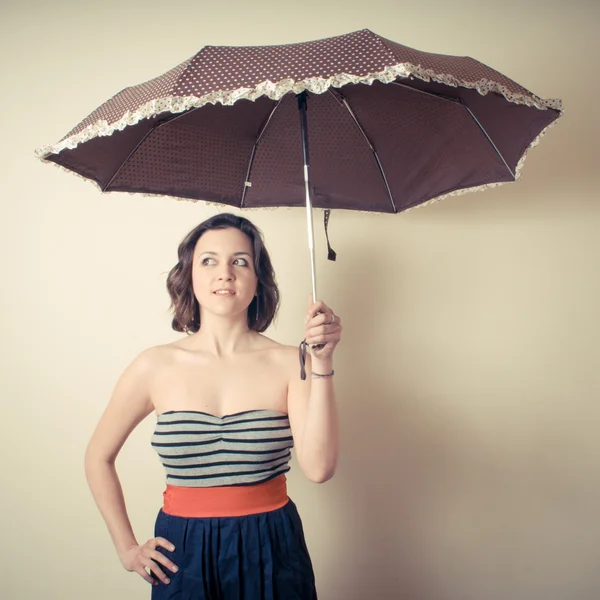 Vintage portrait of young woman with umbrella — Stock Photo, Image