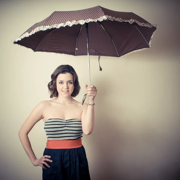Vintage portrait of young woman with umbrella — Stock Photo, Image