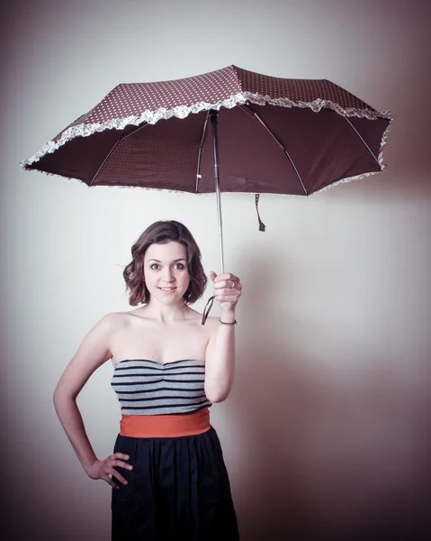 Vintage portrait of young woman with umbrella — Stock Photo, Image