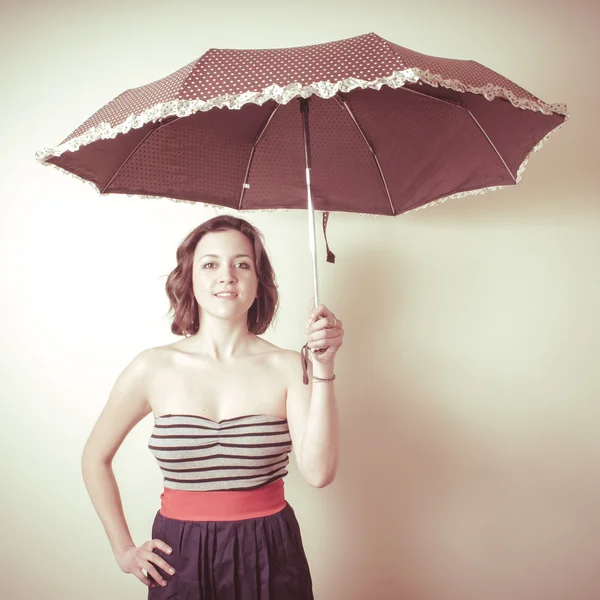 Vintage portrait of young woman with umbrella — Stock Photo, Image