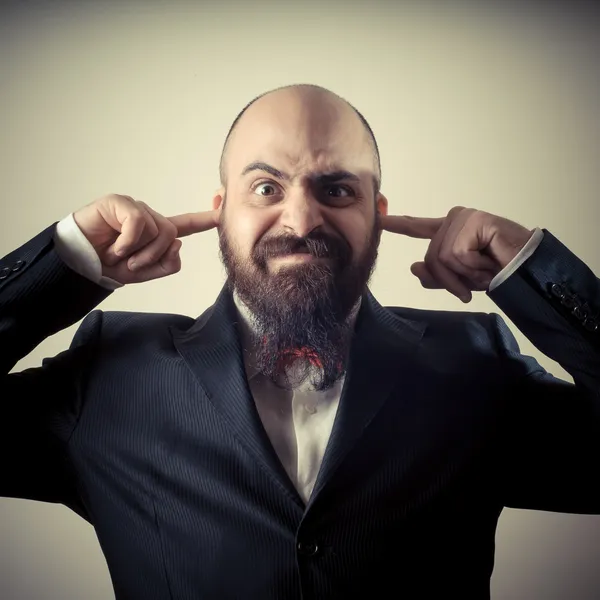 Funny elegant bearded man fingers in the ears — Stock Photo, Image