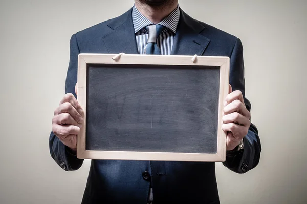 Zakenman bedrijf schoolbord — Stockfoto