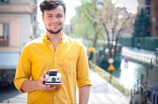 Hipster young man with polaroid — Stock Photo, Image