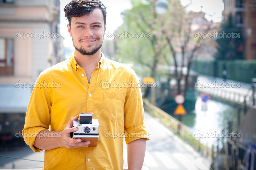 Hipster young man with polaroid — Stock Photo © peus #25449407
