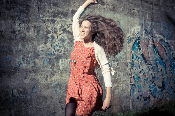 Happy eastern vintage hipster woman jumping — Stock Photo, Image