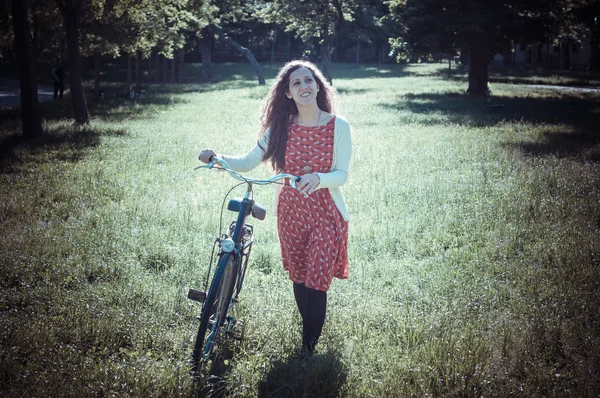 Vintage eastern hipster woman with bike — Stock Photo, Image