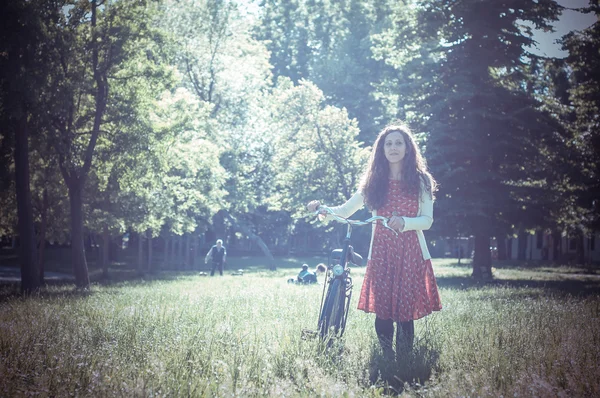 Vintage eastern hipster woman with bike — Stock Photo, Image