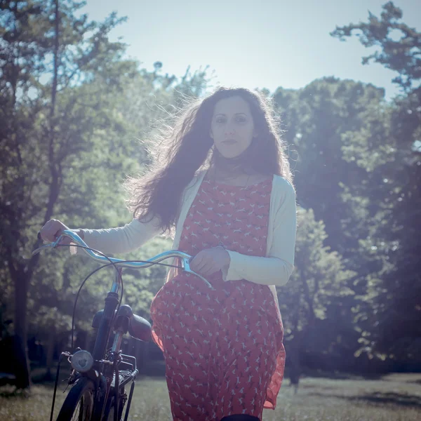 Vintage eastern hipster woman with bike — Stock Photo, Image