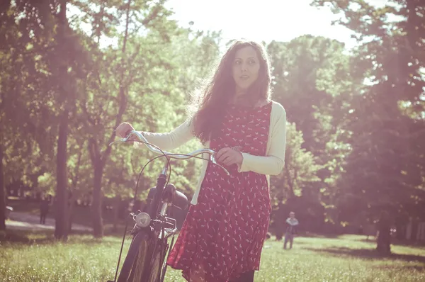 Vintage eastern hipster woman with bike — Stock Photo, Image