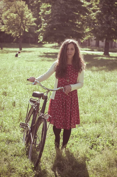 Vintage eastern hipster woman with bike — Stock Photo, Image