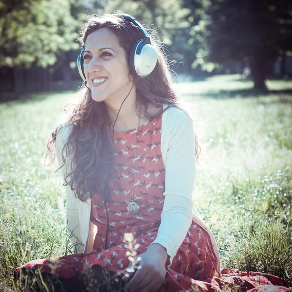 Vintage hipster eastern woman with headphones — Stock Photo, Image