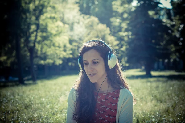 Vintage hipster eastern woman with headphones — Stock Photo, Image