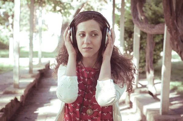 Vintage hipster eastern woman with headphones — Stock Photo, Image