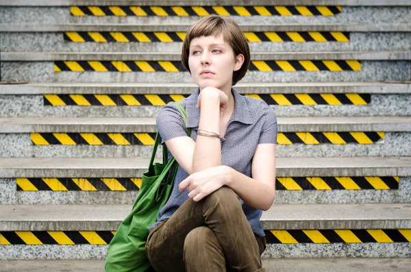 Young beautiful hipster woman sitting on the stairs — Stock Photo, Image