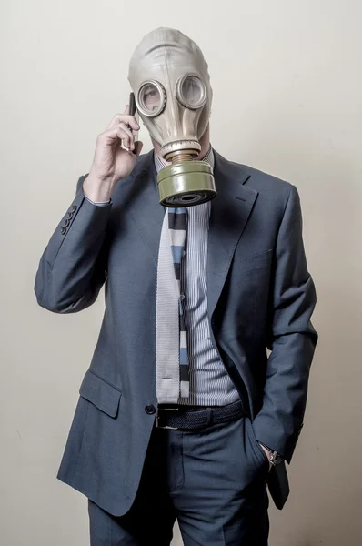 携帯電話、防毒マスクを持ったビジネスマン — ストック写真