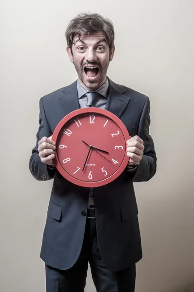 Businessman with clock screaming — Stock Photo, Image