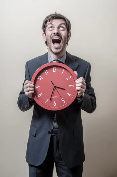 Businessman with clock screaming — Stock Photo, Image