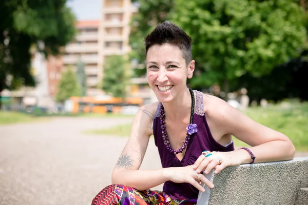 Mooie hipster kort haar vrouw in het park — Stockfoto