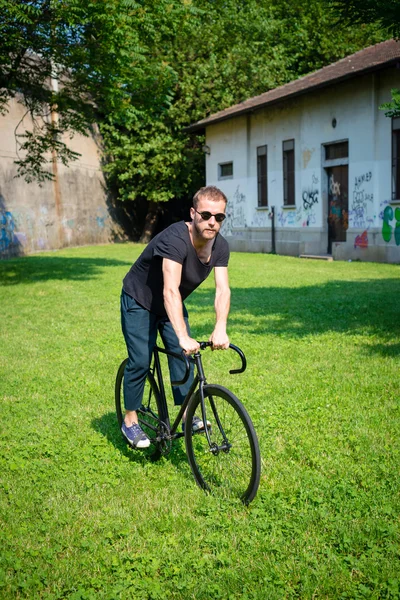 Hipster modern stylish blonde man with bike — Stock Photo, Image