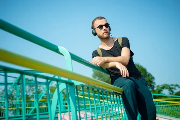 Hipster modern stylish blonde man listening music — Stock Photo, Image