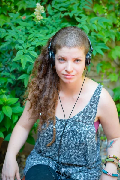 Mooie stijlvolle moderne jonge vrouw luisteren naar muziek — Stockfoto