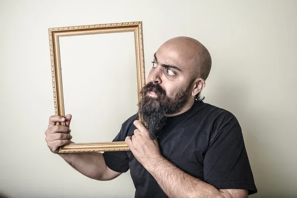 Funny bearded man with golden frame — Stock Photo, Image