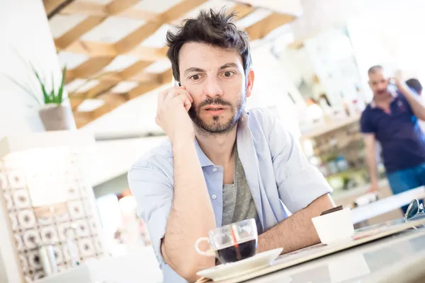 Man at the bar on the phone — Stock Photo, Image