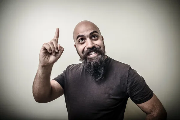 Smiling pointing bearded man — Stock Photo, Image