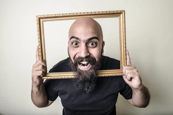 Funny bearded man with golden frame — Stock Photo, Image