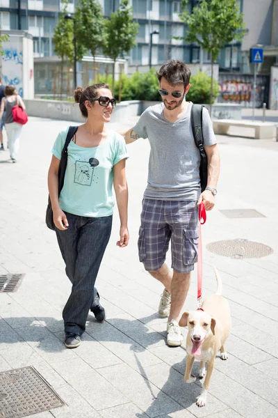 Pareja con perro paseando en la calle —  Fotos de Stock