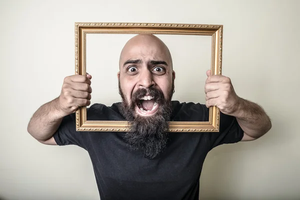 Funny bearded man with golden frame — Stock Photo, Image