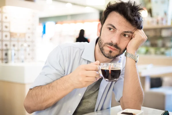 Man at the bar drinking coffee — Stock Photo, Image