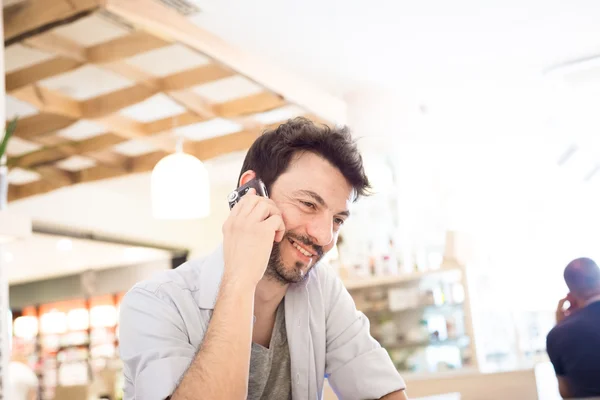 Man at the bar on the phone — Stock Photo, Image