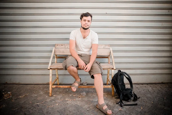 Stylish man sitting on a bench — Stock Photo, Image