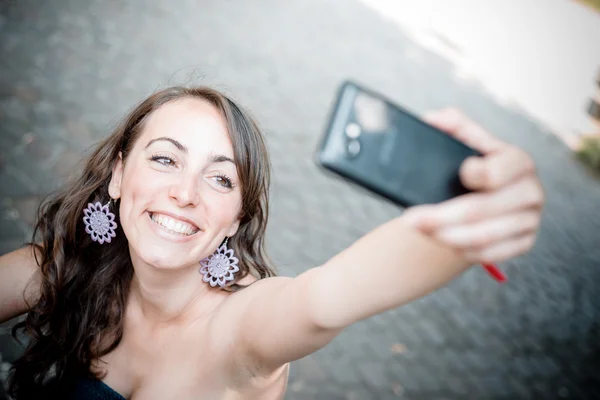 Beautiful woman taking self-portrait — Stock Photo, Image