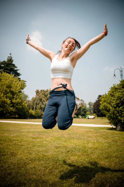 Beautiful woman fitness jumping — Stock Photo, Image