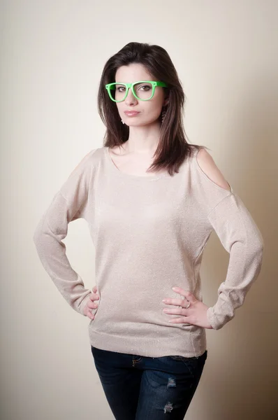 Beautiful young woman with green eyeglasses — Stock Photo, Image