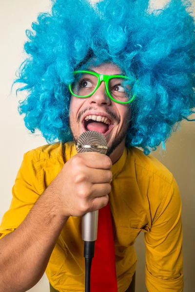 Verrückt lustiger junger Mann mit blauer Perücke — Stockfoto