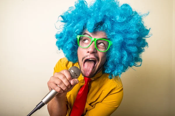 Verrückt lustiger junger Mann mit blauer Perücke — Stockfoto