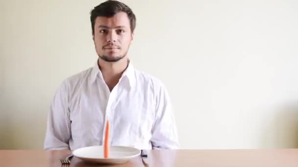 Crazy impossible young stylish man eating a carrot — Stock Video