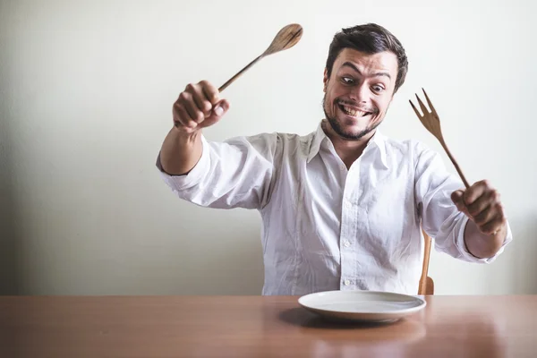 Young stylish man with white shirt eating in mealtimes — Stock Photo, Image