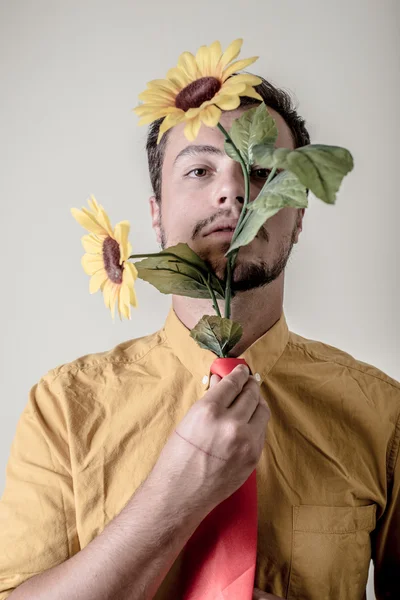 Young stylish man with flowers — Stock Photo, Image