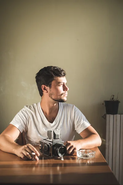 Young stylish hipster man with old camera — Stock Photo, Image
