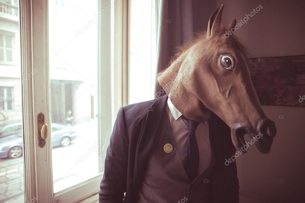 horse mask man in front of window