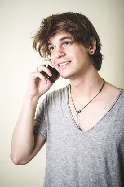 Stylish young blonde hipster man on the phone — Stock Photo, Image
