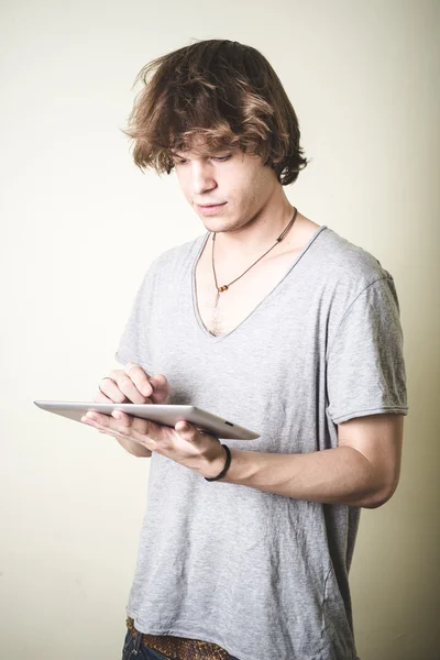 Stylish young blonde hipster man using tablet — Stock Photo, Image
