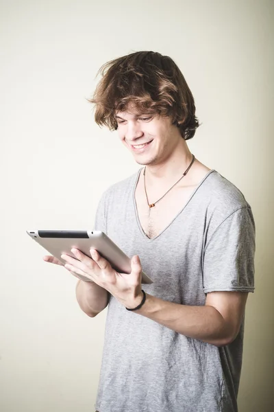 Stylish young blonde hipster man using tablet — Stock Photo, Image