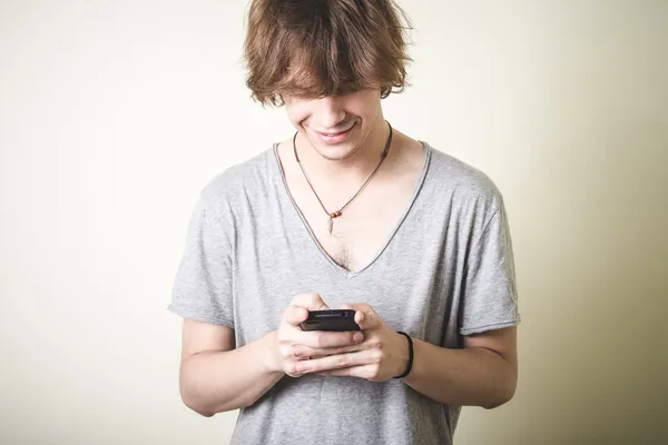 Stylish young blonde hipster man on the phone — Stock Photo, Image