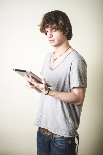 Stylish young blonde hipster man using tablet — Stock Photo, Image