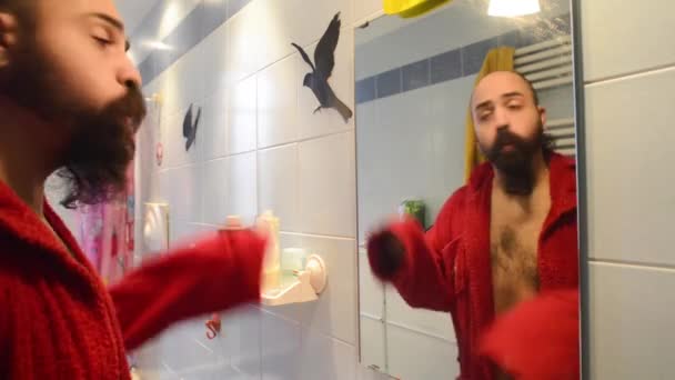 Man in bathroom drying with bathrobe — Stock Video